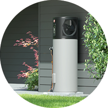 Image of the Rheem AmbiPower 280e heat pump installed against a grey weatherboard home